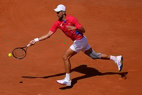 Novak Djokovic returns the ball to Rafael Nadal